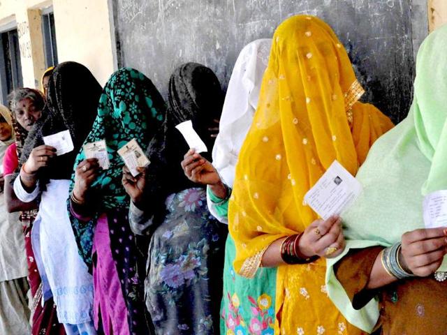 Women voters wait to cast votes for Lok Sabha elections in Faridabad. (PTI Photo)