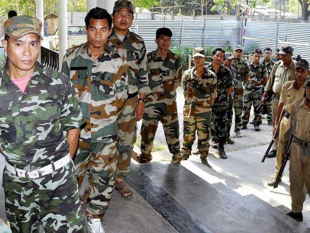 KLNF cadres wait in a queue to cast their postal ballots for the Lok Sabha polls at a designated camp at Taralangso under Karbi Anglong district of Assam. (PTI photo)