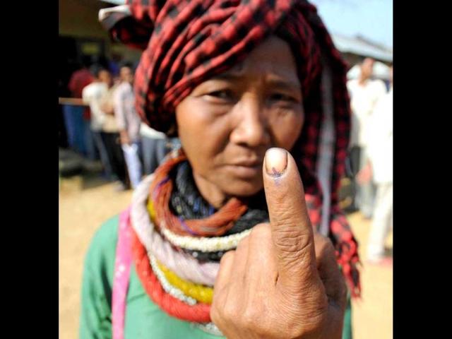 A woman voter shows her ink-marked finger after casting vote for Tripura West Lok Sabha seat outside a polling station in Dhamcherra. (PTI photo)