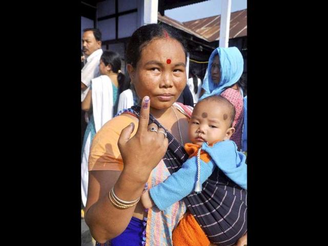 A woman shows her ink-marked finger after casting her vote for Lok Sabha polls at a polling station, at Diphu in Karbi Anglong district of Assam. (PTI photo)