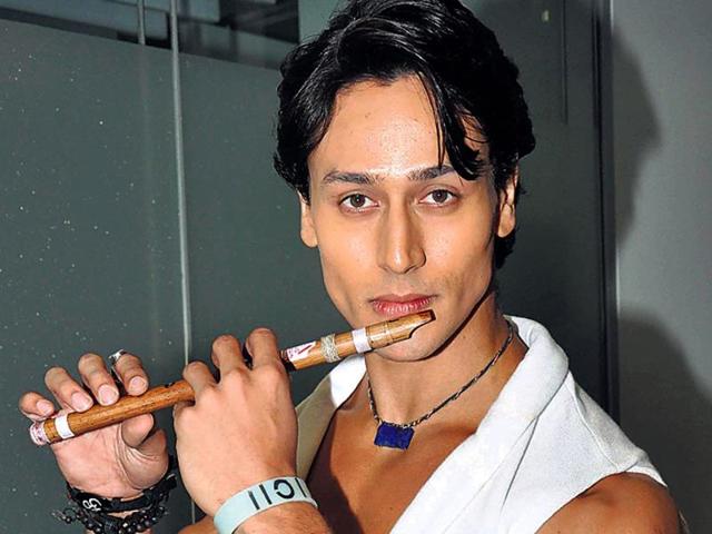 Tiger Shroff poses with a flute at a film event. We wonder if the actor can play the instrument as well.