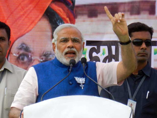 BJP-prime-ministerial-candidate-Narendra-Modi-greets-the-crowd-at-an-election-rally-in-Dhanbad-on-Tuesday-Bijay-HT-Photo