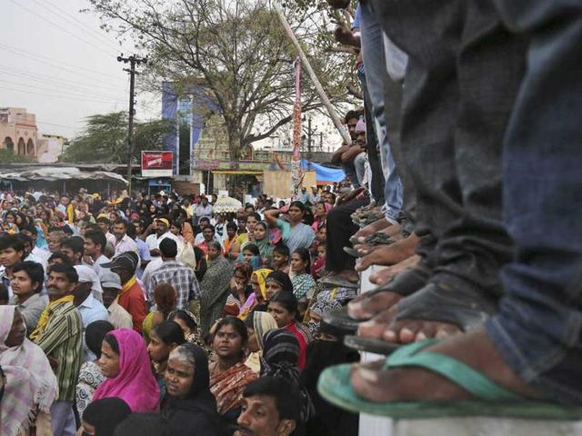 Supporters listen to Telugu Desam Party (TDP) president and former chief minister of Andhra Pradesh, N Chandrababu Naidu, during an election campaign rally in Hyderabad. (AP Photo)