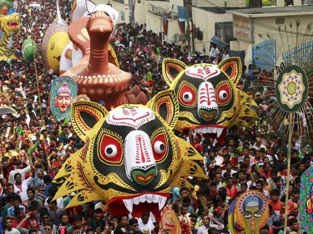 People carry masks and different animal floats down a street during celebrations on Pohela Boishakh, the first day of the Bengali new year, in Dhaka. (Reuters)