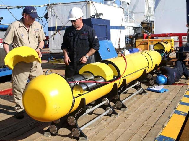 Phoenix International workers Chris Minor (R) and Curt Newport inspect the US Navy’s Bluefin 21 autonomous underwater vehicle (AUV) before deployment in the southern Indian Ocean to look for the missing Malaysia Airlines flight MH370 in this handout picture released by the Australian Defence Force. (Reuters)