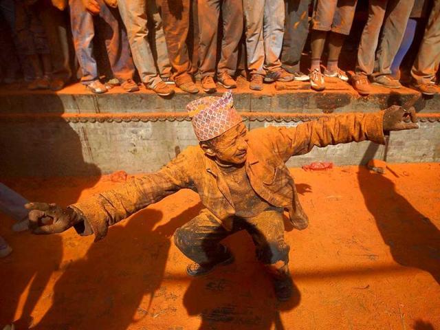 A devotee sings and dances to the beat of traditional instruments while celebrating the "Sindoor Jatra" vermillion powder festival in Thimi, near Kathmandu. (Reuters) A devotee sings and dances to the beat of traditional instruments while celebrating the "Sindoor Jatra" vermillion powder festival in Thimi, near Kathmandu. (Reuters)