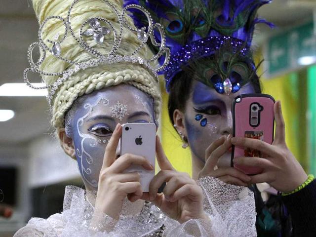 Models with smartphones take pictures of their colleagues during the K-Beauty World Fashion Festival in Gwacheon, South Korea. About 15,000 makeup artists, hairdressers, fashion designers and estheticians from 56 countries participated in the annual event to promote the Korea culture. (AP)