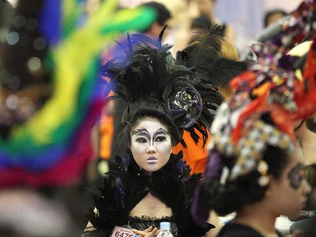 A model gets ready after her makeup done during the K-Beauty World Fashion Festival in Gwacheon. About 15,000 makeup artists, hairdressers, fashion designers and aestheticians from 56 countries participated in the annual event to promote the Korean culture. (AP)