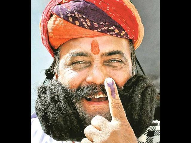 Girdhar-Vyas-who-has-a-17m-long-mustache-shows-his-ink-marked-finger-after-casting-his-vote-in-Bikaner-on-Thursday-PTI-Photo Girdhar-Vyas-who-has-a-17m-long-mustache-shows-his-ink-marked-finger-after-casting-his-vote-in-Bikaner-on-Thursday-PTI-Photo