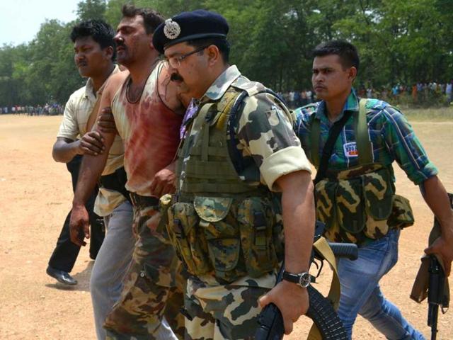 Injured CRPF commander Sanjay Kumar is being taken by jawan in Swang in Bokaro district after a Maoist attack near Lalpania. (HT photo/Krishna)