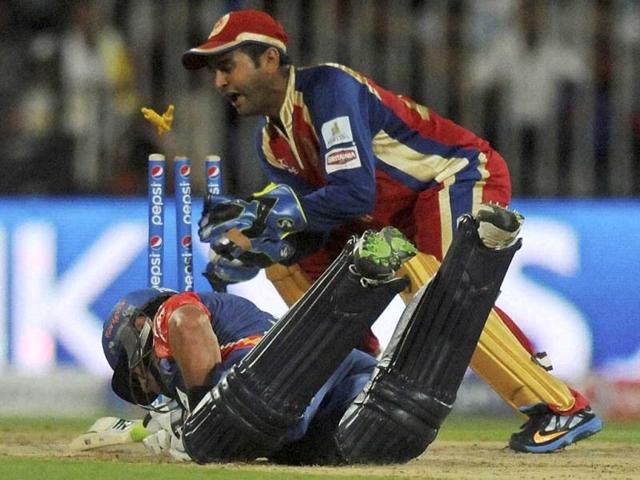 Ross Taylor of the Delhi Daredevils dives to make it to the crease as Parthiv Patel of the Royal Challengers Bangalore attempts a run out during their match in IPL 7 being held at the Sharjah Cricket Stadium in Sharjah. (PTI Photo)