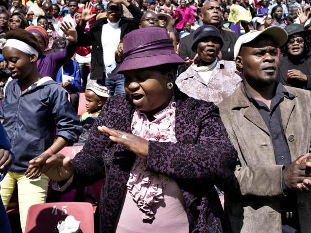 South Africans from every walk of life dance as they crowd the stands at the Ellis Park stadium in Johannesburg where they attended a Good Friday service with the Universal Church of the Kingdom of God. (AFP photo)