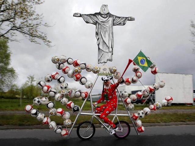 German bicycle designer Didi Senft, also known as "El Diablo", rides his new bicycle creation to commemorate the 2014 FIFA World Cup, in the town of Storkow, Berlin. (Reuters photo)