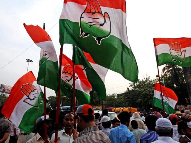 Congress activists hold party flags during an election campaign in support of their party candidate Somen Mitra in Kolkata. (PTI photo)