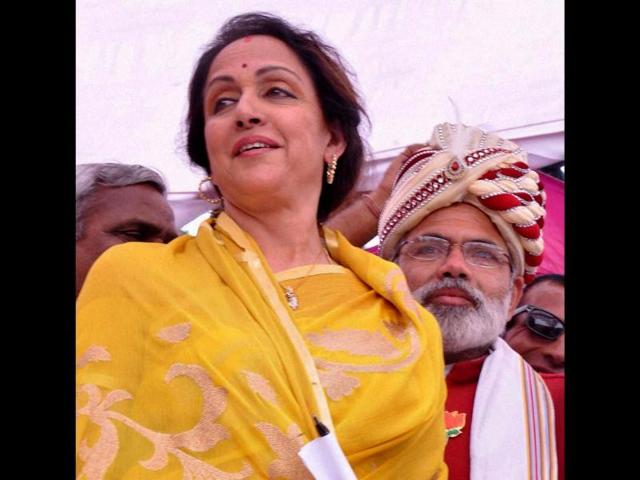 BJP candidate Hemamalini with a supporter dressed up as Narendra Modi during her election campaign in Mathura. (PTI photo)