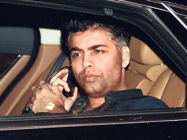 Karan Johar was on phone as he entered the do.