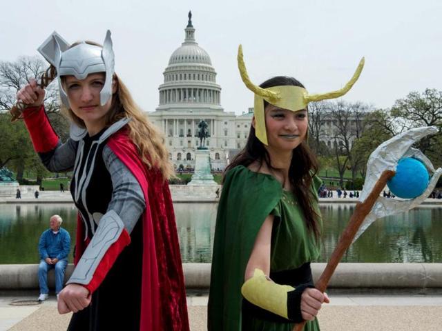 Two middle aged men check out each other's Batman uniforms while waiting at Awesome Con 2014 in Washington. (AFP photo)