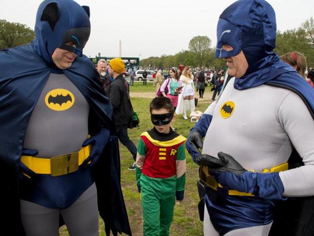People dressed in superhero-style costumes line up for a photo at the Awesome Con 2014 in Washington. (AFP photo)