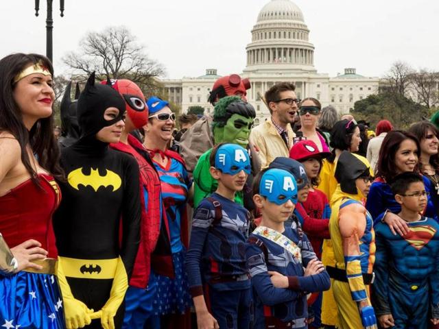 People dressed in superhero-style costumes line up for a photo at the Awesome Con 2014 in Washington. (AFP photo)