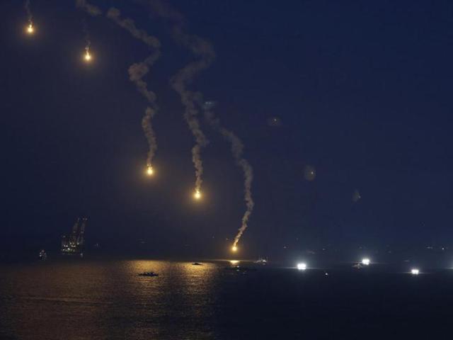 Lighting flares are released over the sea off Jindo where the capsised passenger ship Sewol sank, as fishing boats emit light during the night rescue operation. (Reuters Photo)