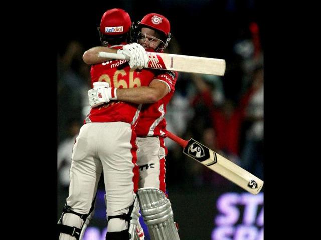 David Miller of Kings X1 Punjab with teammate Cheteshwar Pujara celebrate their win over Rajasthan Royals in their IPL 7 match in Sharjah. (PTI Photo)