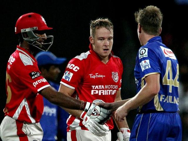 David Miller of Kings X1 Punjab with teammate Cheteshwar Pujara shake hands with James Faulkner of Rajatshan Royals after theirIPL 7 match in Sharjah. (PTI Photo)