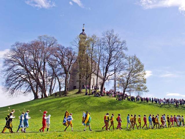 People in traditional costumes attend the St. George ride through the city of Traunstein, Germany (AP Photo)