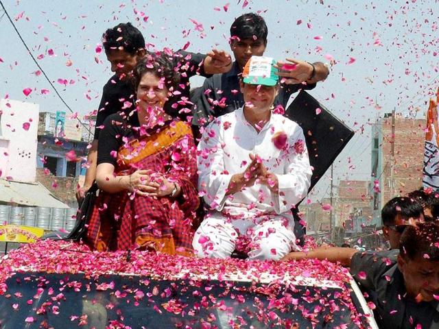 Supporters shower Congress Vice President Rahul Gandhi as he and his sister Priyanka Vadra proceed to file his nomination from Amethi (PTI Photo)