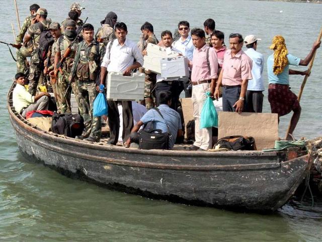 Polling parties leave for election duty by a boat on the eve of Lok Sabha elections in Malda district. (PTI photo)