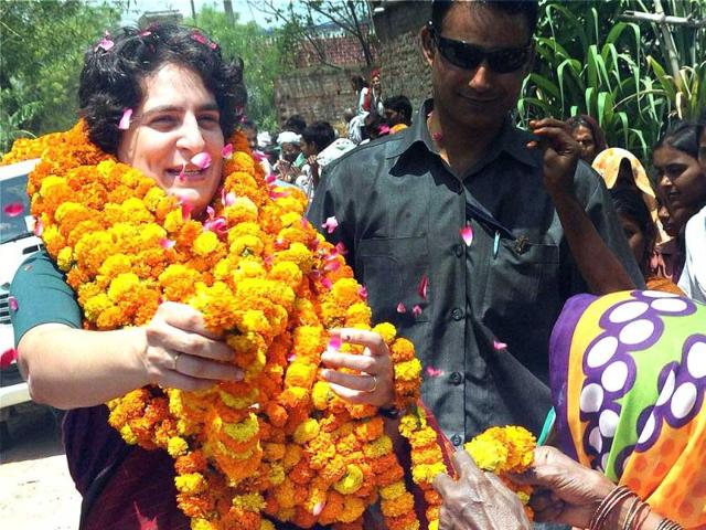 Priyanka Vadra receives garland from a woman at an election campaign meeting for her mother and Congress president Sonia Gandhi in Raebareli. (PTI photo)