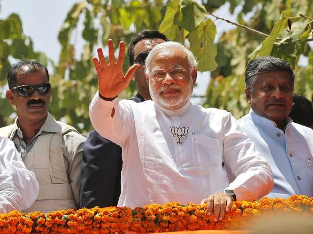 BJP-PM-candidate-Narendra-Modi-greets-supporters-at-a-road-show-before-filing-his-nomination-papers-in-Varanasi-PTI-photo BJP-PM-candidate-Narendra-Modi-greets-supporters-at-a-road-show-before-filing-his-nomination-papers-in-Varanasi-PTI-photo