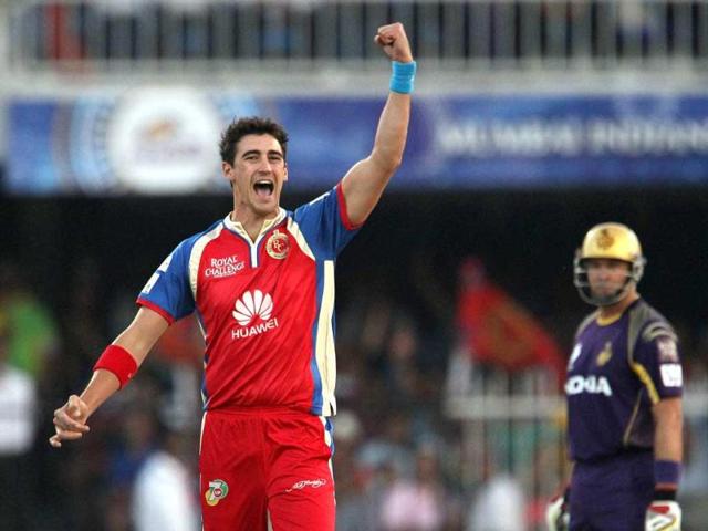 RCB's Mitchell Starc celebrates the wicket of KKR's captain Gautam Gambhir during IPL 7 at the Sharjah cricket stadium in Sharjah. (PTI Photo)