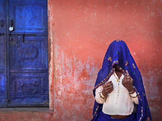 A woman shows her finger marked with indelible ink after casting her vote during the 6 phase of polling of the Lok Sabha elections at a village near Sawai Madhopur, Rajasthan. (AP photo)
