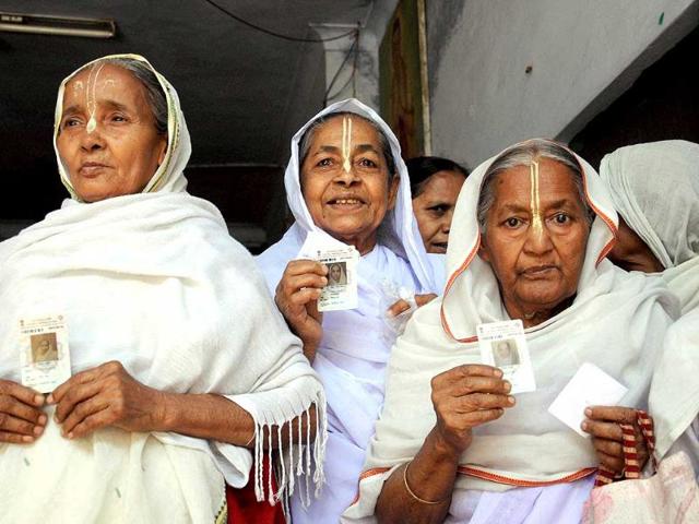 Widows standing in a queue to cast their votes for Lok Sabha polls at a polling booth in Vrindavan. (PTI photo)