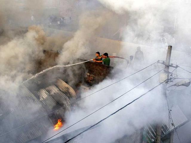 Firefighters try to douse a fire at a cotton factory in Allahabad. (Reuters photo)