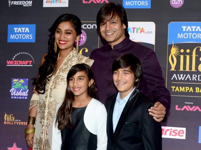 Presenter of IIFA Rocks and nominee for best performance in a negative role, Vivek Oberoi poses with his wife on the green carpet at the Tampa Convention Center. (AFP)