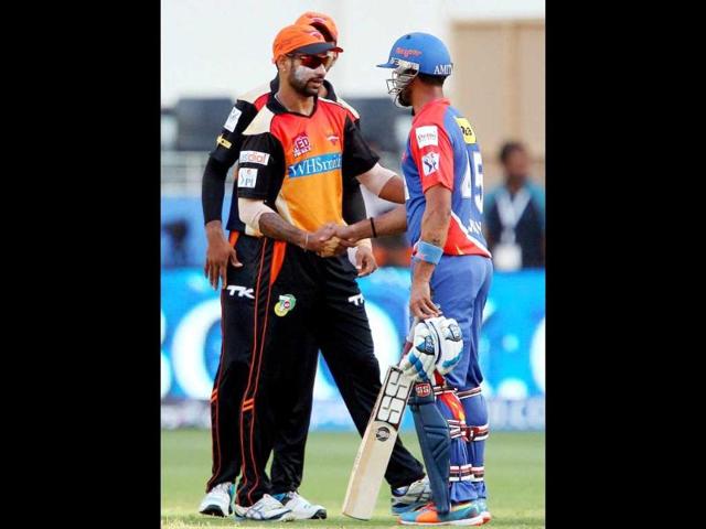 Sunrisers Hyderabad captain Shikhar Dhawan shakes hands with Delhi Daredevils batsman after winning the IPL 7 match in Dubai (PTI Photo)