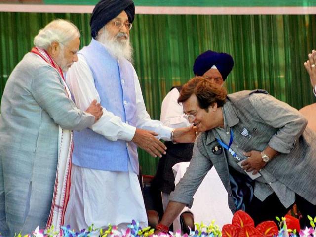 BJP PM candidate Narendra Modi looks on as party candidate Vinod Khanna seeks blessings of Punjab CM Parkash Singh Badal during an election rally in Pathankot. (PTI photo)