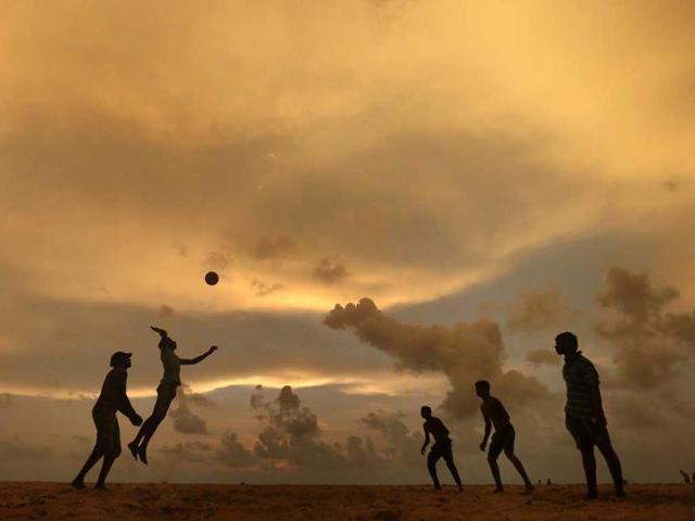 A man jumps to hit the ball while playing beach volleyball on a beach in Colombo. (Reuters photo)