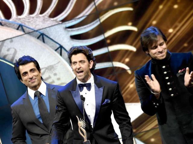 Sonu Sood, Hrithik Roshan and Vivek Oberoi appear on stage at the Mid Florida Credit Union Amphitheater during the IIFA Magic of the Movies. (AFP)