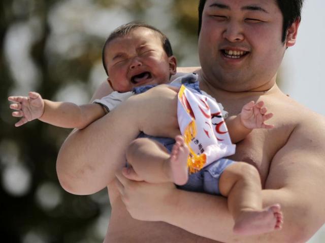 The babies participated in the annual traditional ritual performed as a prayer for healthy growth of them. (AP photo)