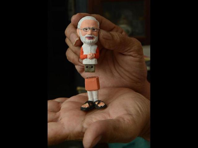 A pen drive with the image of BJP's PM candidate Narendra Modi is shown during a launch ceremony by the 'Gujarat Gaurav Fan Club' (GGFC) in Ahmedabad. (AFP photo)