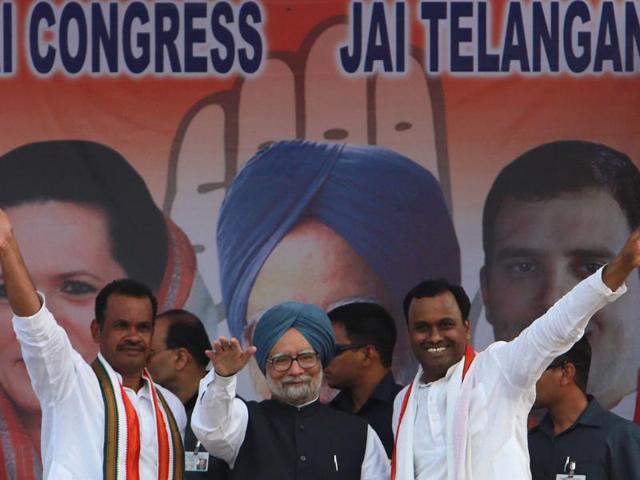 PM Manmohan Singh and other party leaders greet supporters during an election rally in Bhongir, Andhra Pradesh. (AP Photo)