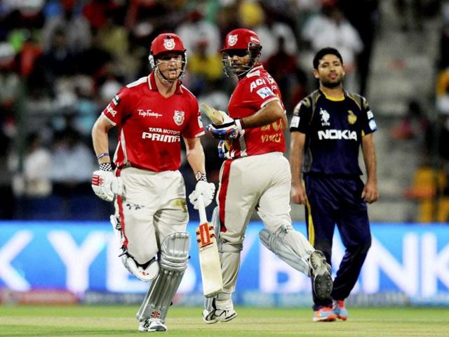 Virender Sehwag and George Bailey of Kings X1 Punjab run between the wickets against Kolkata Knight Riders during their IPL7 match in Abu Dhabi. (PTI Photo)