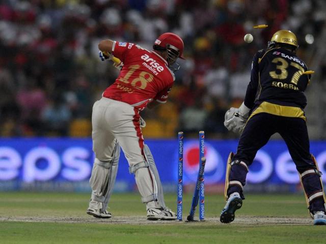Virender Sehwag of Kings X1 Punjab gets bowled out by Piyush Chawla of Kolkata Knight Riders during their IPL match in Abu Dhabi. (PTI Photo)