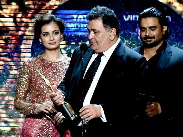 Bollywood actor Rishi Kapoor receives the award for Best performance in a Negative Role during the fourth and final day of the 15th International Indian Film Academy (IIFA) Awards at the Raymond James Stadium in Tampa, Florida. (AFP)