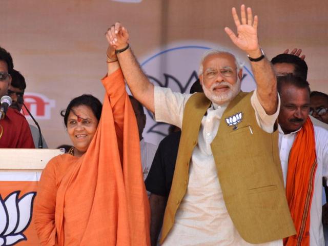 BJP Prime Minister candidate for Lok Sabha election Narendra Modi and BJP candidate from Jhansi constituency Uma Bharti during a rally, in Jhansi. (Photo my Manoj Yadav/ Hindustan Times)