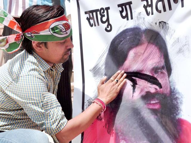 A-Congress-supporter-blackens-a-poster-of-yoga-guru-Ramdev-who-made-controversial-statements-on-Rahul-Gandhi-in-Bikaner-PTI-Photo A-Congress-supporter-blackens-a-poster-of-yoga-guru-Ramdev-who-made-controversial-statements-on-Rahul-Gandhi-in-Bikaner-PTI-Photo