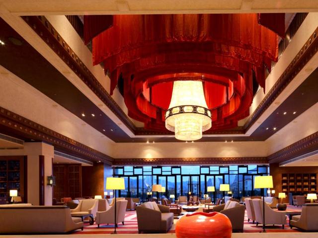 Shangri-La Lhasa's lobby features a 6.5-meter tall chandelier made from 61,000 pieces of crystal, draped in a flowing red fabric to evoke a prayer wheel.