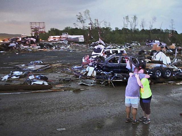 Lori Berseth (R) is consoled after searching for her missing Black Labrador dog, Lucille, after a tornado destroyed the town of Mayflower, Arkansas. (Reuters)